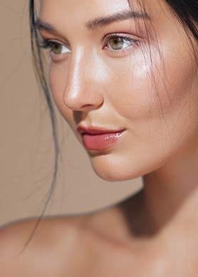 Junge Frau mit glatter Haut und natürlichem Glow steht für Hautpflege und Beauty
