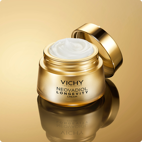 Vichy NEOVADIOL Longevity Cream in goldenem Tiegel vor goldenem Hintergrund